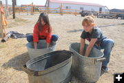 Rinsing out the soap. Photo by Dawn Ballou, Pinedale Online.